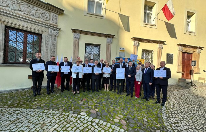 Zdjęcie przybyłych wójtów oraz księży trzymających czeki